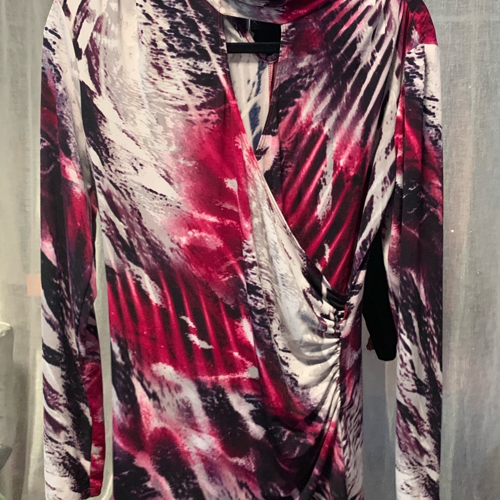 Long sleeve pink and white shirt with cleavage.